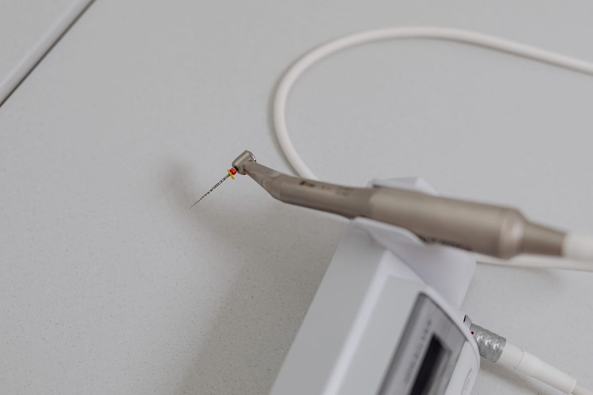 An endodontic handpiece with a fine file, ready on the clinic counter
